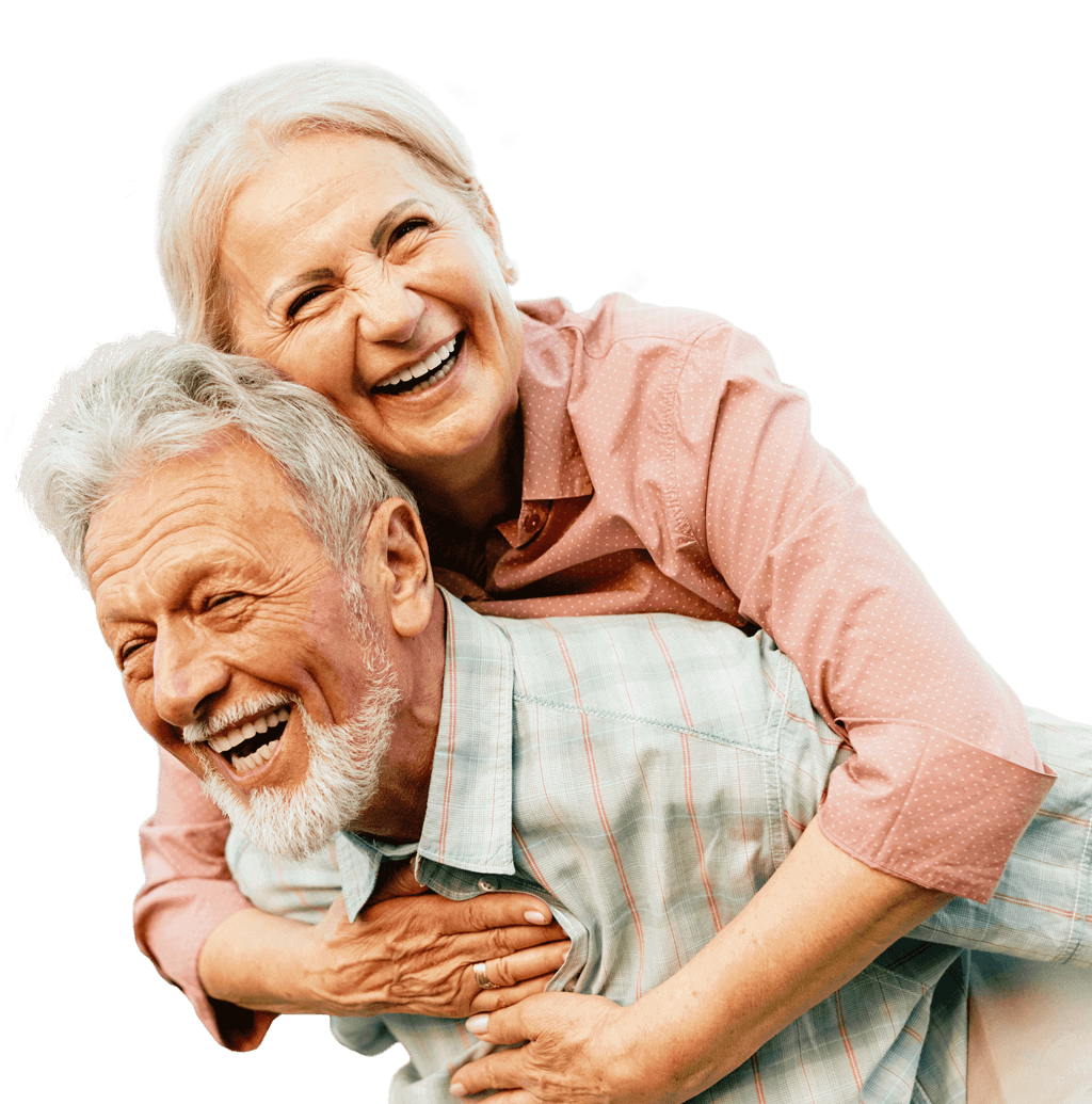 Happy older woman hugging her laughing husband from behind.